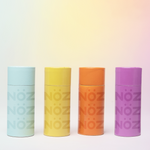 Load image into Gallery viewer, Blue, yellow, orange, and purple Nöz sunscreen lined up in a row from left to right.
