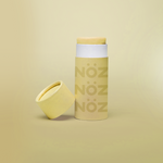 Load image into Gallery viewer, Opened yellow Nöz sunscreen stick with cap leaned up against left side of sunscreen stick.
